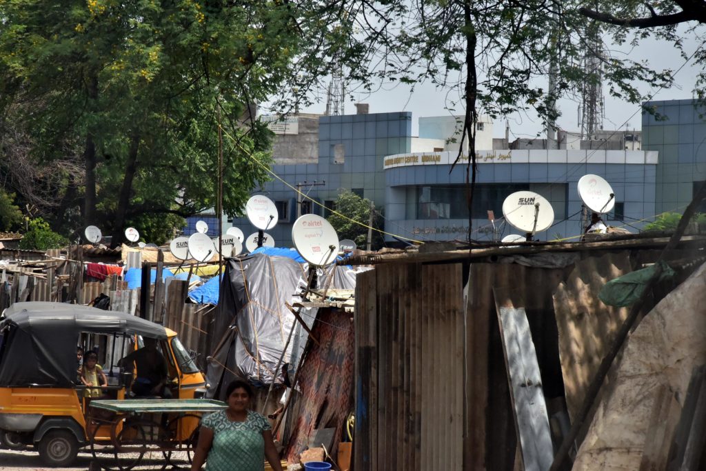 Slum Area people connected to Television to live better mobile life as well