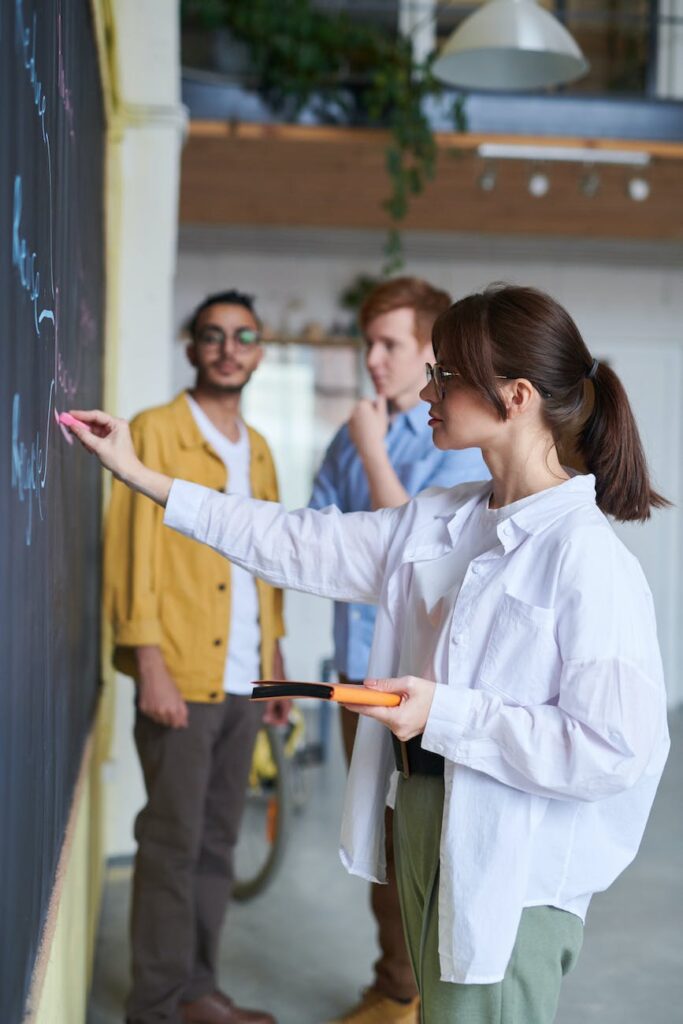 photo of woman writing on blackboard, How Teachers Learn, Teaching, poem 
