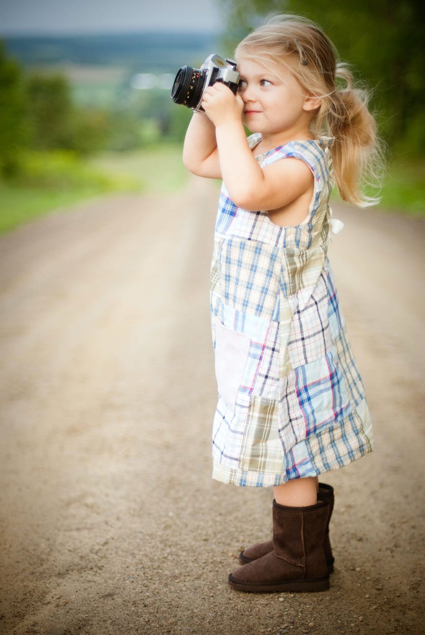 girl with blonde hair and wearing blue and white plaid dress and capturing picture during daytime, Encourage Young Minds, Work, Jobs, Business 